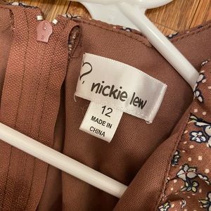 Adorable, flattering dress! Has ruffles in front and zipper in back.